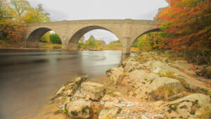 Historic stone bridge over river with autumn foliage – landscape photography digital download & UK wall art print